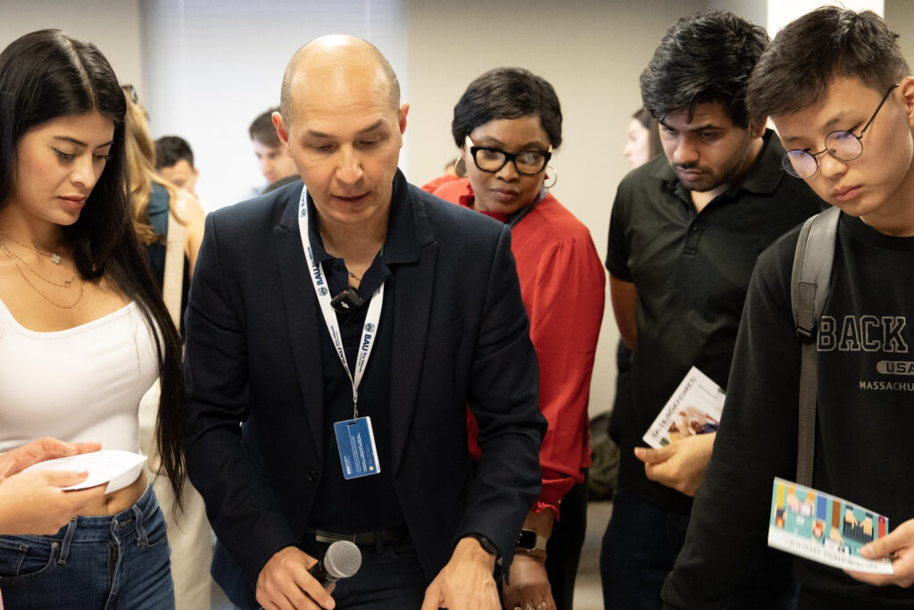 Diverse group attending a seminar, engaged and discussing contents of brochures in a professional setting.