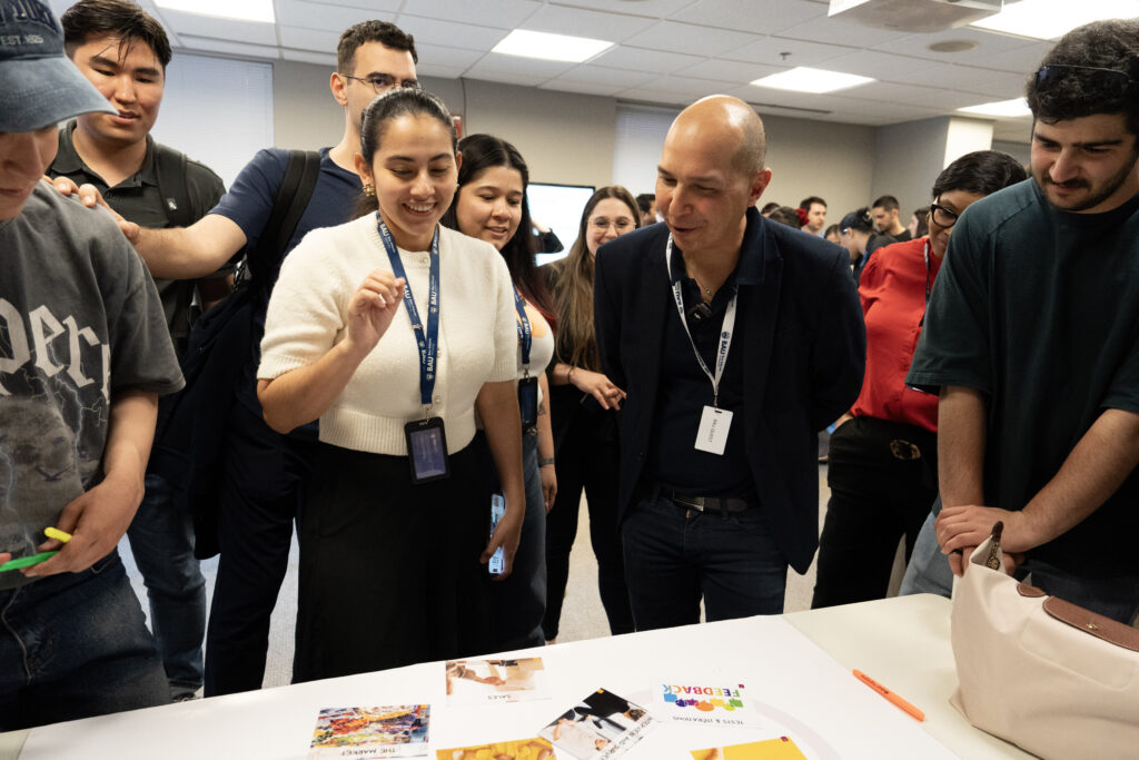 Students engage in collaborative project discussion at a workshop, sharing ideas and feedback with enthusiasm.