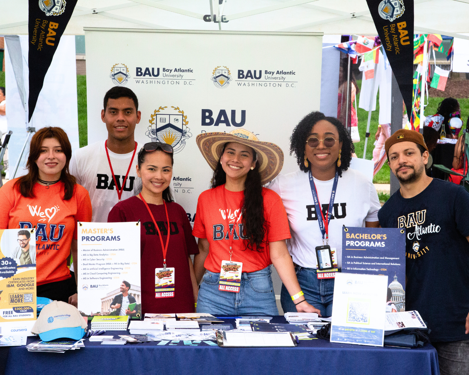 University event booth with students promoting BAU programs, showcasing Master's and Bachelor's options.