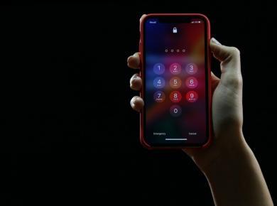 How To Start a Career in Cyber Security: A Roadmap to Success 19 Hand holding smartphone with passcode lock screen, showcasing security and authentication features on a black background.