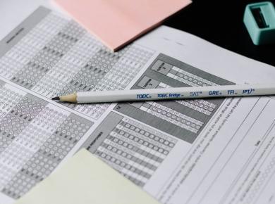 ACT vs. SAT: Key Differences to Help You Pick the Right Test 45 Standardized test answer sheets with a pencil, ready for TOEIC, SAT, and GRE exams.