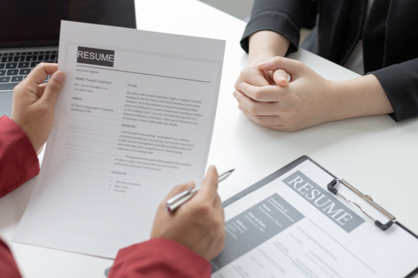 a job applicant in an interview, where the interviewee is observing the resume