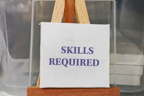 Small canvas on easel displaying the text Skills Required in a professional setting.