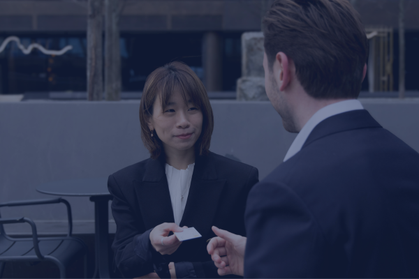 Business professionals exchanging business cards to make career connections