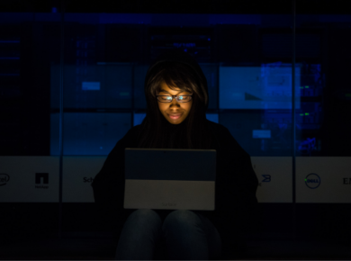 Cloud Computing vs. Software Engineering: Which Degree Leads the Future of Tech? 55 Woman working on a laptop in a server room deciding between cloud computing vs. software engineering
