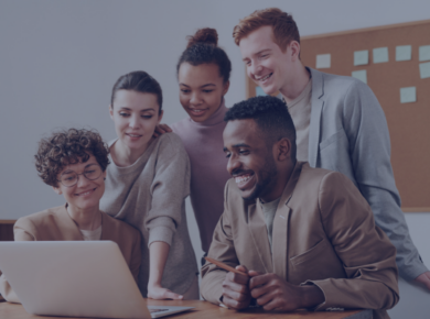 Remote Internships for Students: How to Turn Experience into a Career 41 A diverse group of young professionals smiling while collaborating on a laptop, capturing teamwork and networking in remote internship environments.