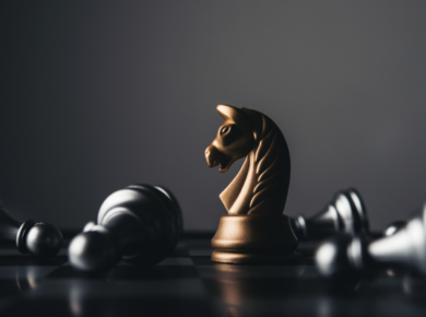 Global Career Skills: 7 Key Skills Employers Expect from International Graduates 54 Golden knight chess piece stands amidst fallen pieces on a board, representing strategy and victory.