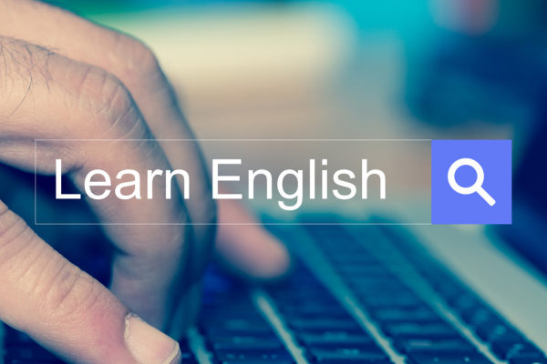 10 Essential Tips for New ESL Teachers: How to Teach English Like a Pro 10 Hand typing on laptop keyboard with Learn English search bar overlay.