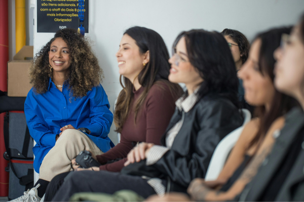 From Basic to Advanced: How to Master English Grammar in the U.S. 9 Group of diverse women sitting in a classroom setting, engaging in a discussion and smiling attentively.