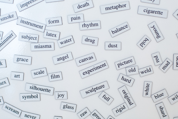 How to Improve Your English Vocabulary Quickly: Intensive ESL for Beginners 6 Magnetic English vocabulary words scattered on a white surface, including angel, canvas, sculpture, and balance.