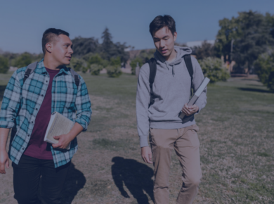 Balancing Work and Study: A Commuter Student’s Guide 22 Two students walking on campus with books, talking and wearing casual outfits representing commuter student culture.