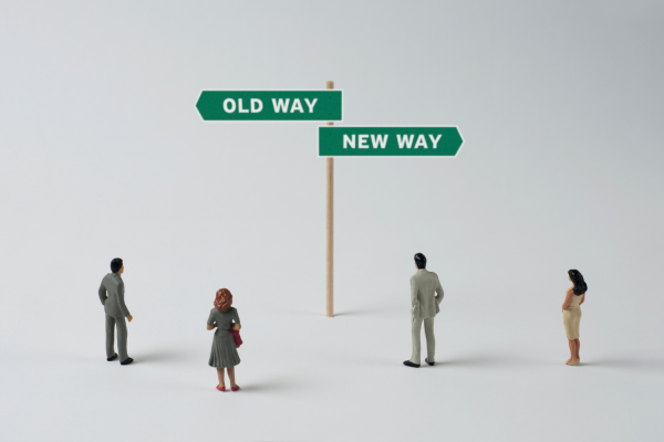 Balancing Work and Study: A Commuter Student’s Guide 12 Miniature figures face signpost with Old Way and New Way directions, symbolizing change and decision-making.