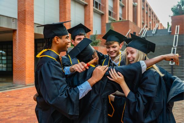 Popular STEM Degrees in 2026: The Ultimate Guide for International Students 9 Graduates in caps and gowns celebrating together outside a building.