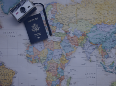 Financial Literacy: Managing Multi-Currencies and Budgeting Tips for International Students 49 Vintage camera and passport on a world map, symbolizing travel and adventure across continents.