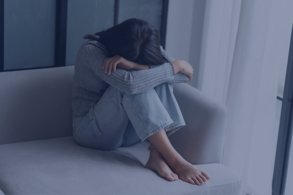 10 Strategies for Overcoming Culture Shock while Studying Abroad in 2026 1 A person sitting on a couch with head down, reflecting sadness of a culture shock faced while studying abroad