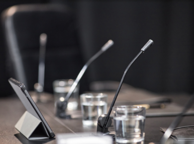From Data to Diplomacy: Data Science Jobs in Government and Public Policy 22 Conference room with microphones, tablets, and glasses of water on a table, ready for a meeting or discussion.