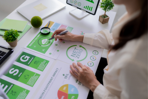 From Data to Diplomacy: Data Science Jobs in Government and Public Policy 9 Person analyzing eco-friendly business metrics and ESG reports, promoting sustainability with data on a white desk.