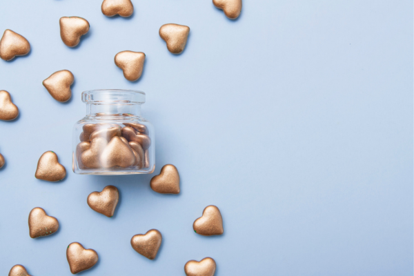 Why Donate to STEM Education? The Ripple Effect of Giving 9 Gold heart-shaped chocolates in a glass jar on a blue background, perfect for Valentine's gifting and decor.