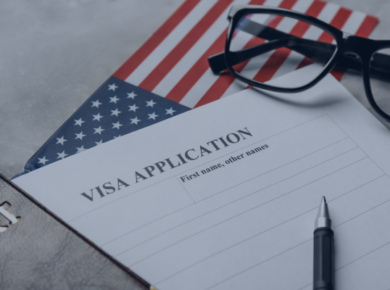 The New F-1 Visa Rules 2026: Simplified for International Students 63 Visa application form with pen on USA flag background, next to glasses and a passport.