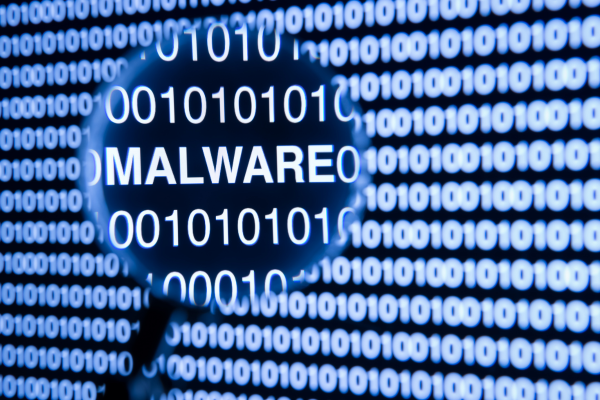 Understanding Cybersecurity Frameworks: Essential Cybersecurity Certification Tips 9 Magnifying glass highlighting the word malware over binary code background, symbolizing cybersecurity threats.