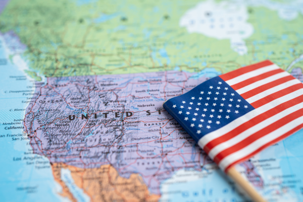 New F-1 Visa Rules for International Students: Your Questions Answered 5 Close-up of a small American flag on a map of the United States.