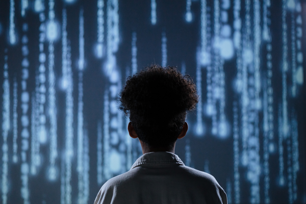 The Future of Business Development: How AI Is Changing the D.C. Market 9 Business professional facing a wall of data and binary code, representing AI's role in business.