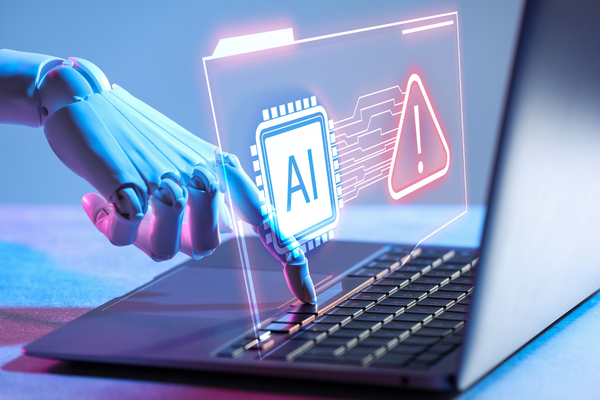 Robotic hand pointing to an AI icon with a warning symbol on a laptop screen.