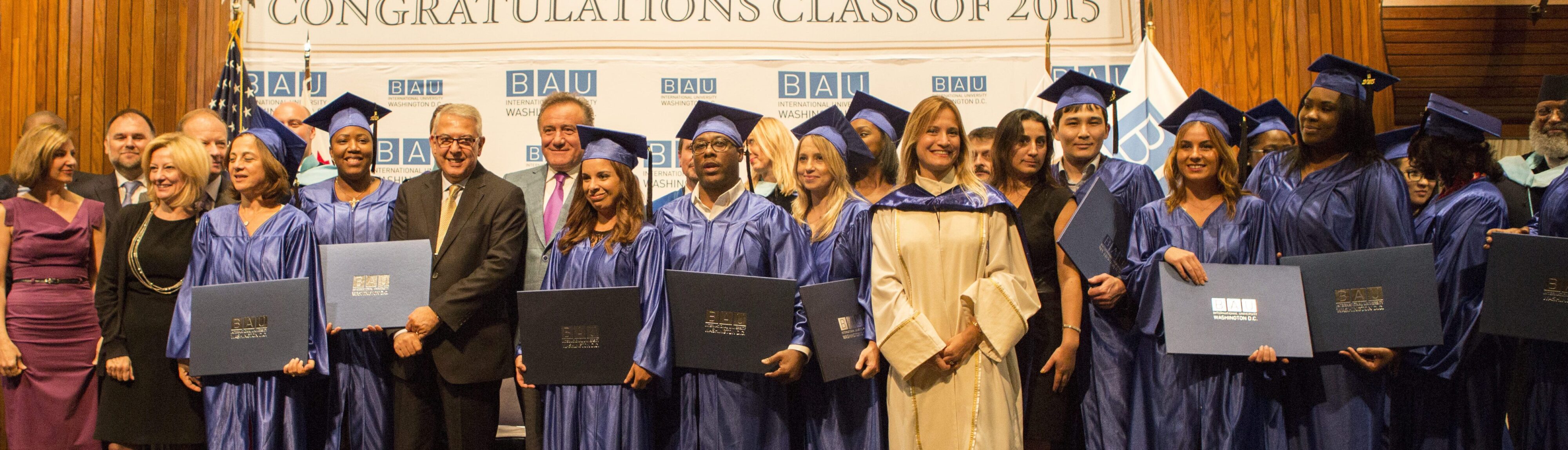 Graduates in blue gowns holding diplomas at BAU International University Washington D.C. ceremony, Class of 2015.