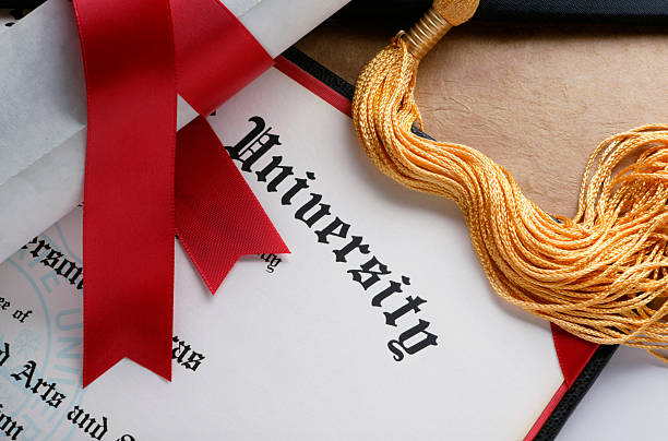 University diploma with red ribbon and graduation cap tassel, symbolizing academic achievement and success.
