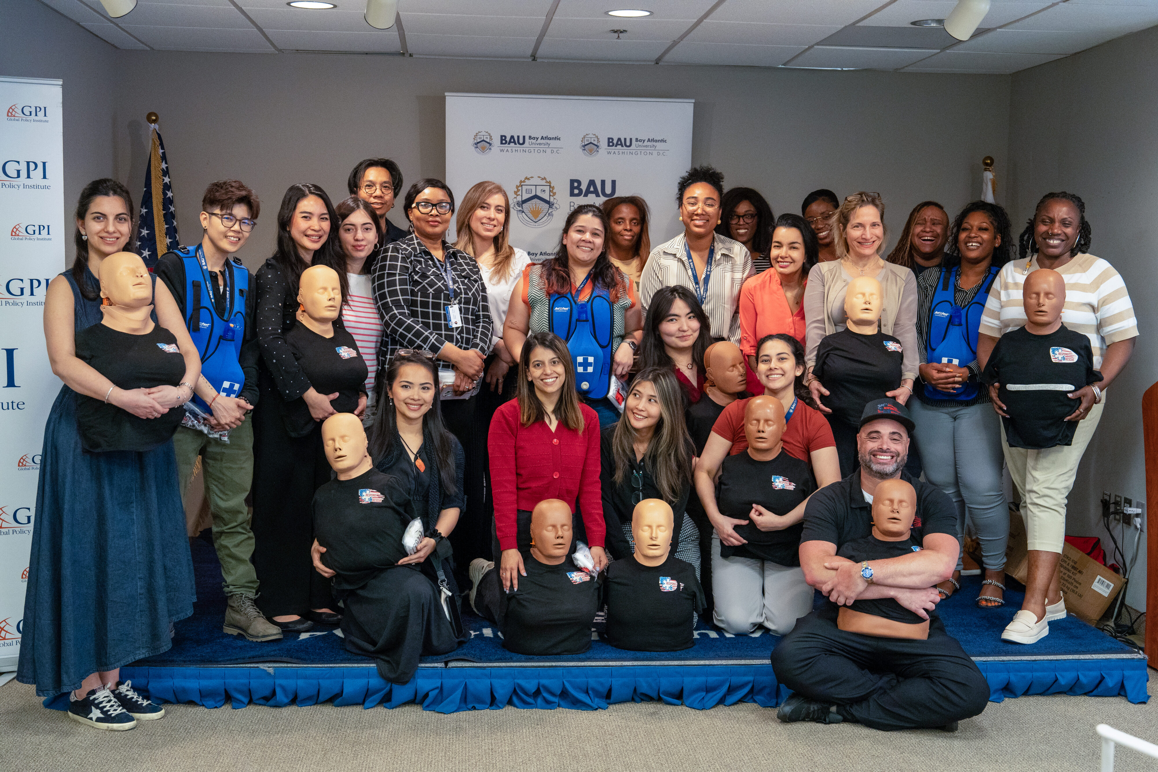 Group photo at CPR training event with mannequins and trainers from BAU, Washington DC.