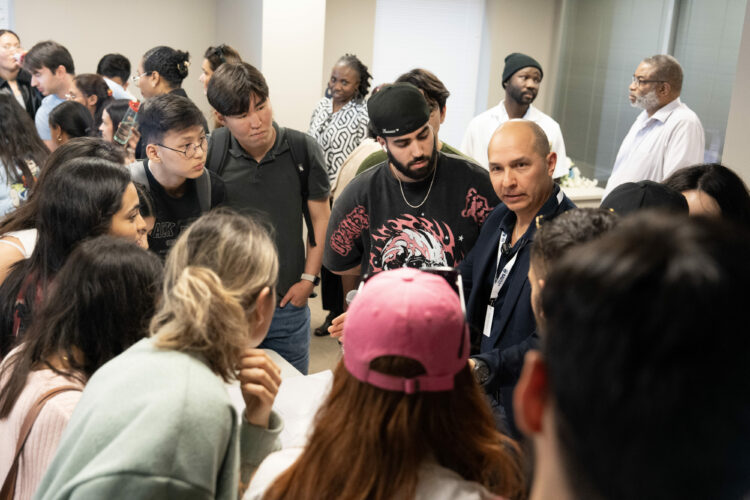 A group of people engaged in a lively discussion at a networking event, with diverse expressions and attentive listening.