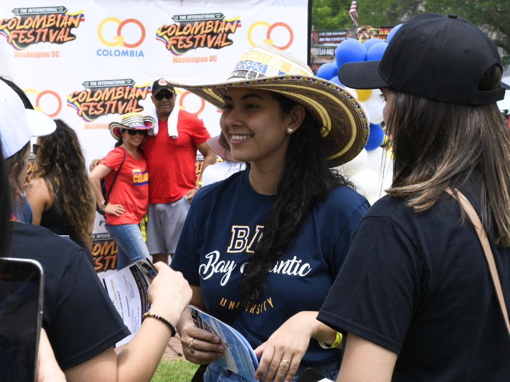 People enjoying the Colombian Festival in Washington D.C., wearing traditional hats and socializing.