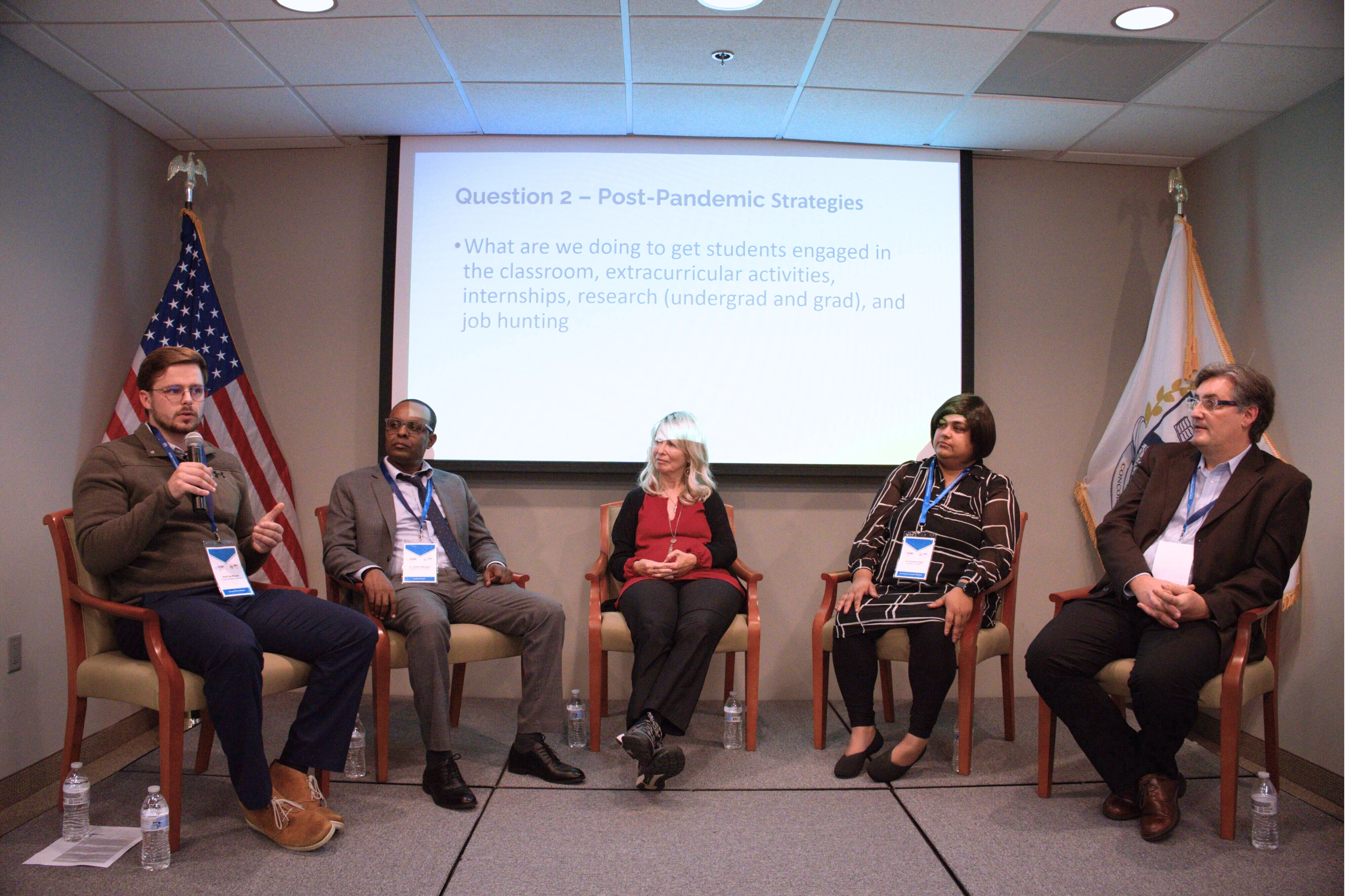Panel discussion on post-pandemic education strategies with five experts sitting on stage.