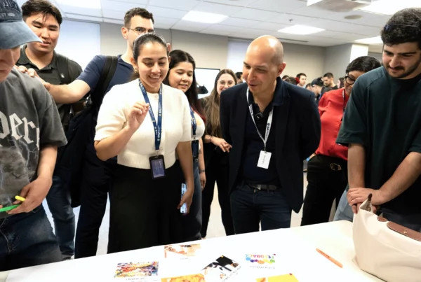 People gathered around a table reviewing documents in a casual office setting.