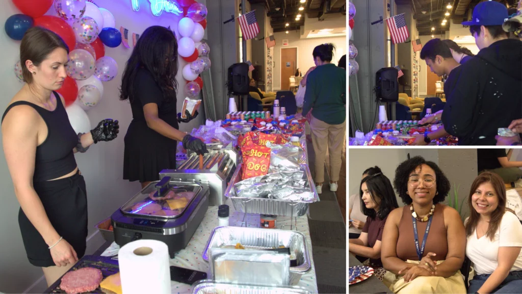 People enjoying a festive indoor BBQ event with hot dogs and burgers, decorated with balloons and American flags.