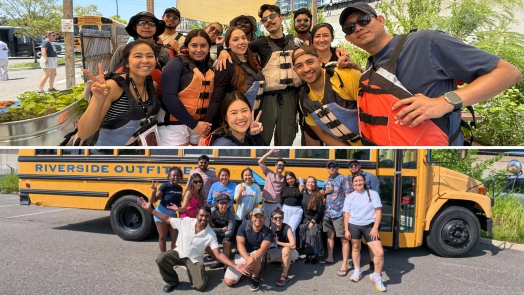 Group smiling in life vests before outdoor adventure; posing by Riverside Outfitters bus in bright sunshine.