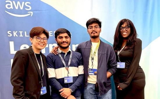Group of diverse people at an AWS event, smiling and wearing conference badges.
