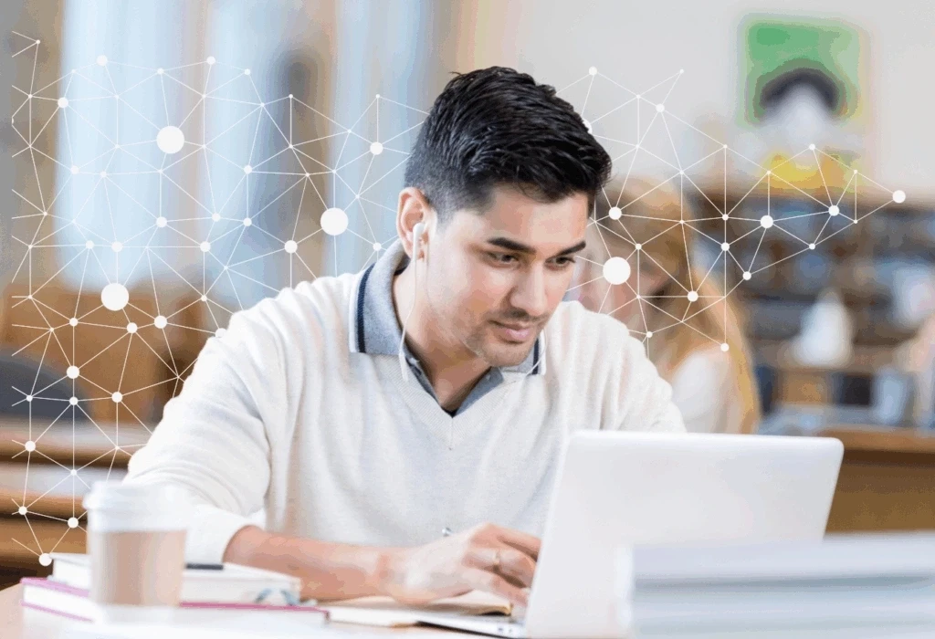 Man working on laptop in library with network graphics overlay, focused on digital connectivity and technology.