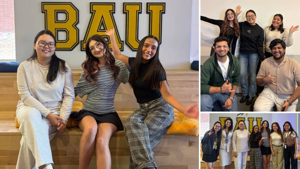 Diverse group of students smiling in front of BAU sign, celebrating together in casual attire.