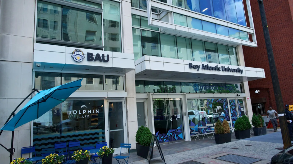 3 Front view of Bay Atlantic University and Dolphin Cafe, featuring outdoor seating and umbrellas.