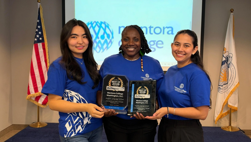 Three Mentora College team members smiling and holding the BusinessRate Best of 2026 English Language School award plaques in Washington, D.C.